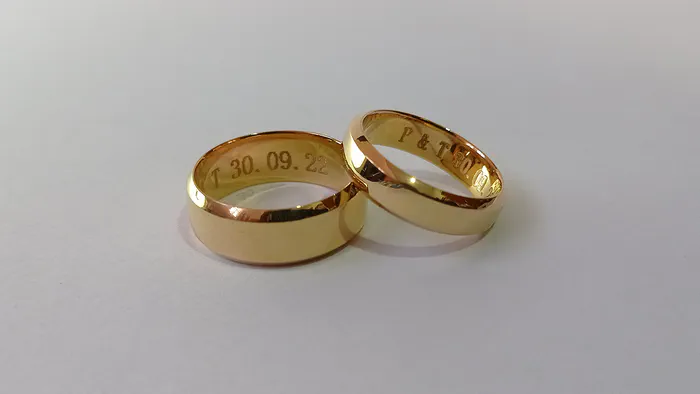 Our co-founder's wedding rings, engraved with their initials and wedding date